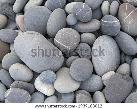Pebbles background, abstract background with round gray stones,

 Royalty-Free Stock Photo #1939183012