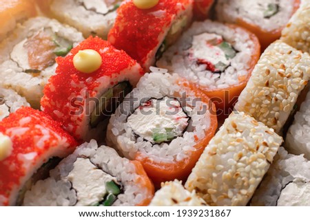 Fresh delicious sushi rolls. Rolls Philadelphia with salmon and California with tuna. Japanese cuisine background.