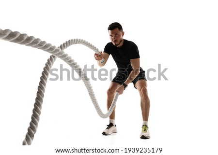 Caucasian professional sportsman training isolated on white studio background. Muscular, sportive man practicing. Royalty-Free Stock Photo #1939235179