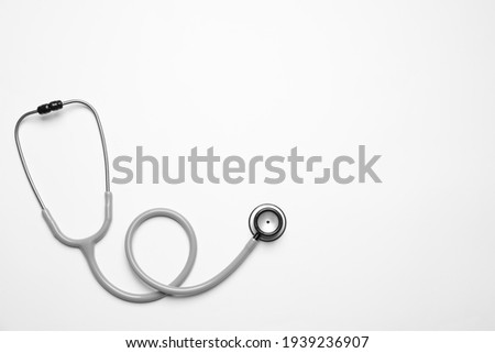 Stethoscope on white background, top view. Space for text Royalty-Free Stock Photo #1939236907