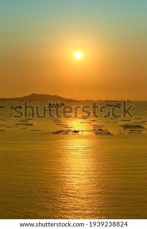 Sunset view overlooking Koh Sichang and cargo ship in sea.