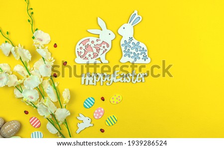 Easter background, spring greeting card with happy easter text on a yellow paper, top view photo