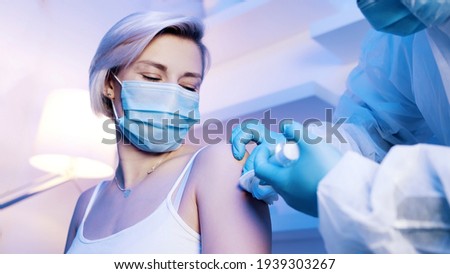 Woman receiving vaccine against covid 19. High quality photo