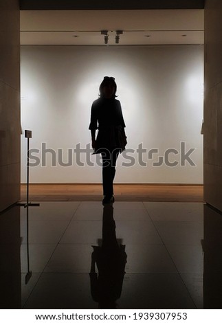 A Standing shadow of woman indoor museum