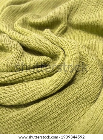 The texture of the soft knitted fabric is like a yellow background