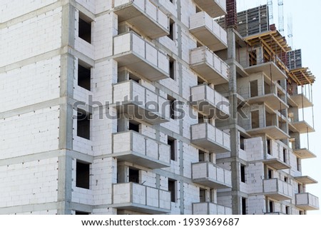 The facade of modern residential building under construction. The construction of modern apartment buildings
