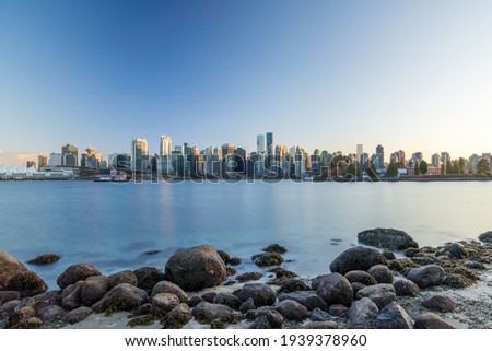 Vancouver downtown skyline panoramic view at sunset time. Skyscrapers reflection on the Vancouver Harbour. British Columbia, Canada.