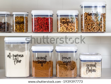 Neatly organized and labeled baking ingredients in BPA-free plastic storage containers Royalty-Free Stock Photo #1939397773