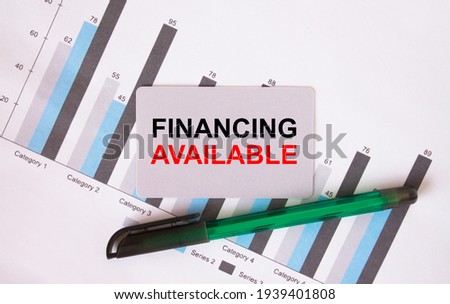 Business card with text Financing Available. Diagram and green pen. Concept photo