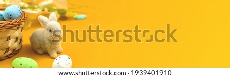 Banner cute bunny with colorful ester eggs in nests, spring and festive background photo
