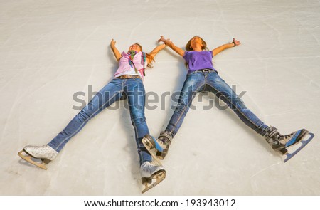 Image of group cute young girls lying on the ice at the Medeo