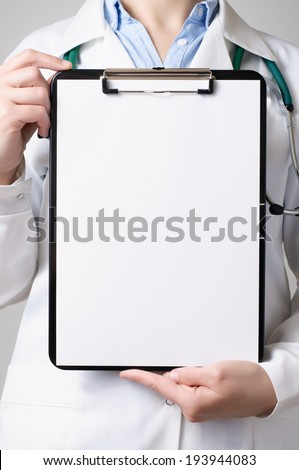 Female doctor showing a clipboard with blank paper