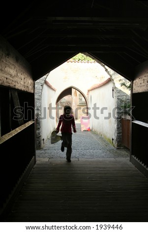 Young girl running through the bridge  in Amberg. Bavaria