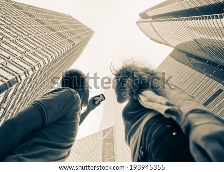 Young people photographed on a cell phone skyscrapers of Hong Kong