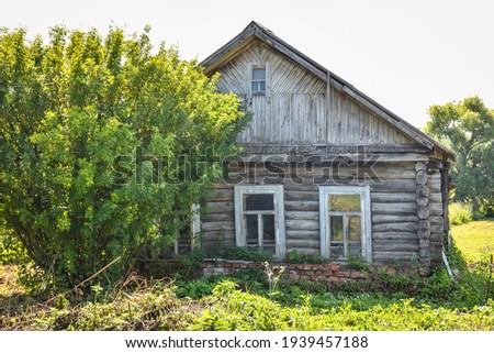 wooden house in the village against the sky surrounded by greenery Royalty-Free Stock Photo #1939457188