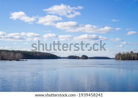 Sunny spring day at ice lake in Katrineholm Sweden. Beautiful scandinavian nature and landscape. Calm, peaceful photo.