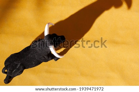 Aerial view of a souvenir bull in a simulated alvero of a bullring with the shadow of the bull projected Royalty-Free Stock Photo #1939471972