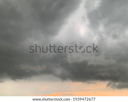 Thunder cloud, Nimbostratus Clouds A gray Style rolls are round to each other in sheets or layers and Huge scary storm it's going to rain heavily at Thailand.no focus Royalty-Free Stock Photo #1939472677