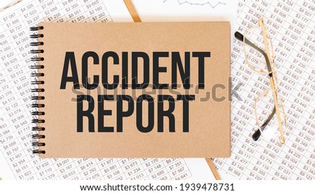 Text ACCIDENT REPORT on brown paper notepad on the table with diagram. Business concept