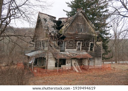 Old abandoned and neglected house. Seasonal.  Royalty-Free Stock Photo #1939494619