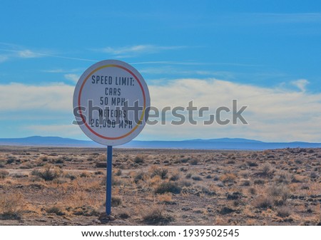 Car and Meteor speed limit sign. On the road to the Meteor Crater Natural Monument on the Arizona Rocky Plain