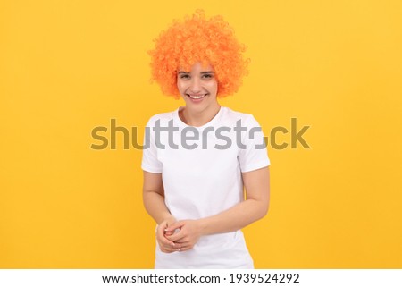 happy freaky woman in curly clown wig for party, happiness.