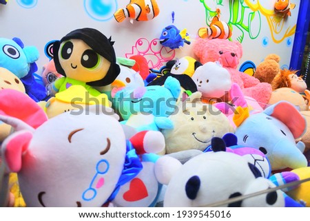 a bunch of doll at arcade game machine