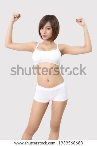 young asian woman in white sport wear at studio and gray  background
