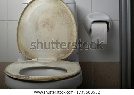 Old and dirty toilet seat covers, yellow stains. Royalty-Free Stock Photo #1939588552