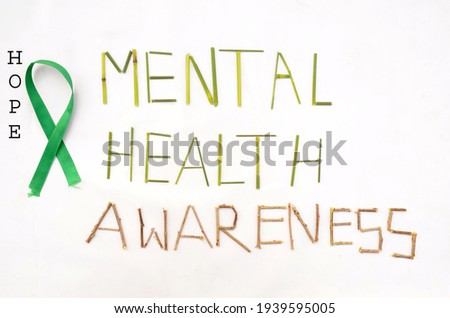the the green ribbon cross hope mental health awareness concept on the white background.