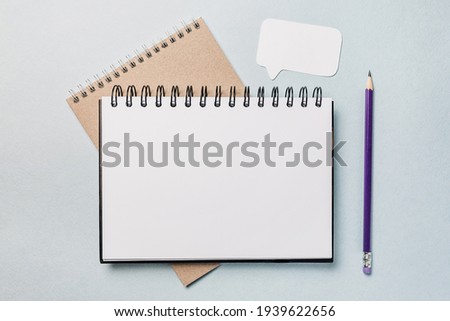 Notepad, white sticker and pensil on the desk. Mock up in copy space office background. It is important not to forget the note Royalty-Free Stock Photo #1939622656
