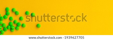 green pill banner on yellow background, top view