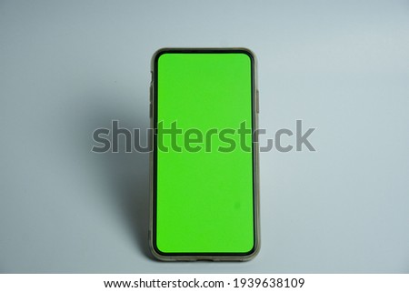 Phone mobile telephone with a vertical green screen in tram chroma key smartphone technology cell phone on white background isolate
