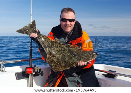Happy angler with halibut fish