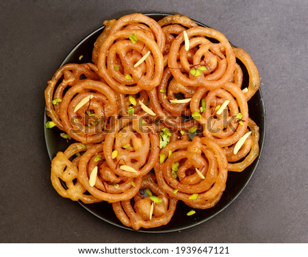 Jalebi or Imarti is a very popular indian desert, soaked in sugar syrup. Royalty-Free Stock Photo #1939647121