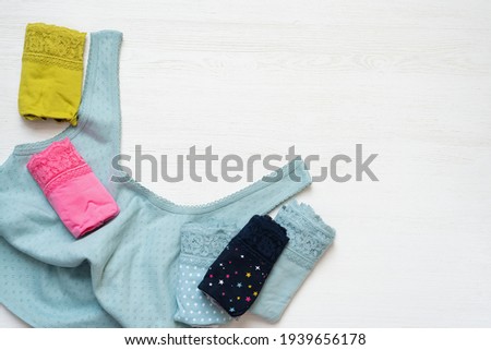 Woman panties and shirt on the white table background.