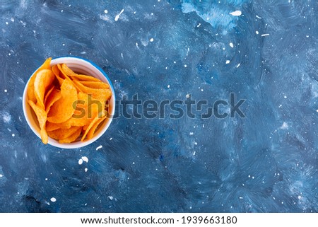Spicy chips on dark blue galaxy background. High quality photo