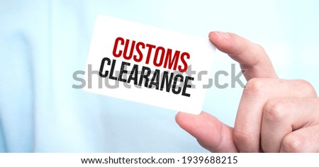 Businessman holding a card with text CUSTOMS CLEARANCE,business concept