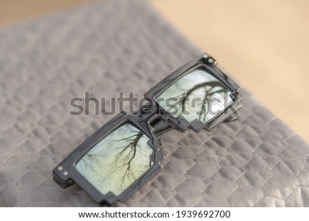 Pixel sunglasses model with yellow lenses and black frame shoot in a summer day closeup. Selective focus