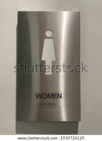Toilet sign for women  on gray background.