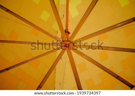 Picture of a still industrial fan inside a shopping mall.