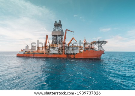 Deepwater drilling ship in operational condition seen at oil field. Royalty-Free Stock Photo #1939737826
