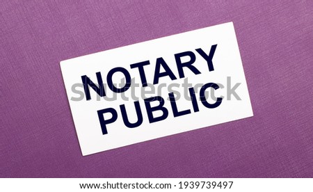On a lilac background, a white card with the words NOTARY PUBLIC