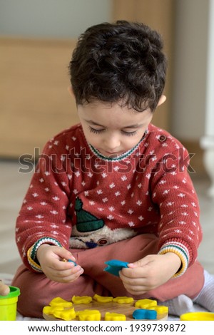 Boy playing with play dough