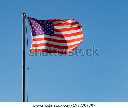 Tattered United States Flag wavy in a strong wind