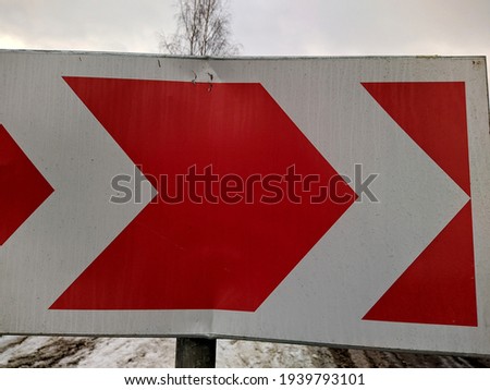 Dangerous turn. Warning traffic road sign board red and white arrows.