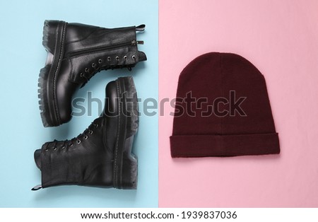 Leather boots and hat on blue pink pastel background. Top view. Flat lay