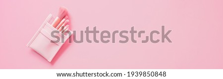 Beauty and makeup concept from blush brush set on pink background. web banner size.