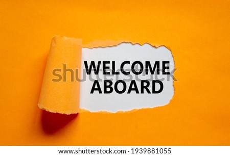 Welcome aboard symbol. Words 'Welcome aboard' appearing behind torn orange paper. Beautiful orange background. Business, welcome aboard concept, copy space.
