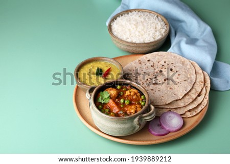 vegetarian Indian thali or Indian home food with lentil dal, cauliflower curry, roti or Indian flat bread and rice Royalty-Free Stock Photo #1939889212